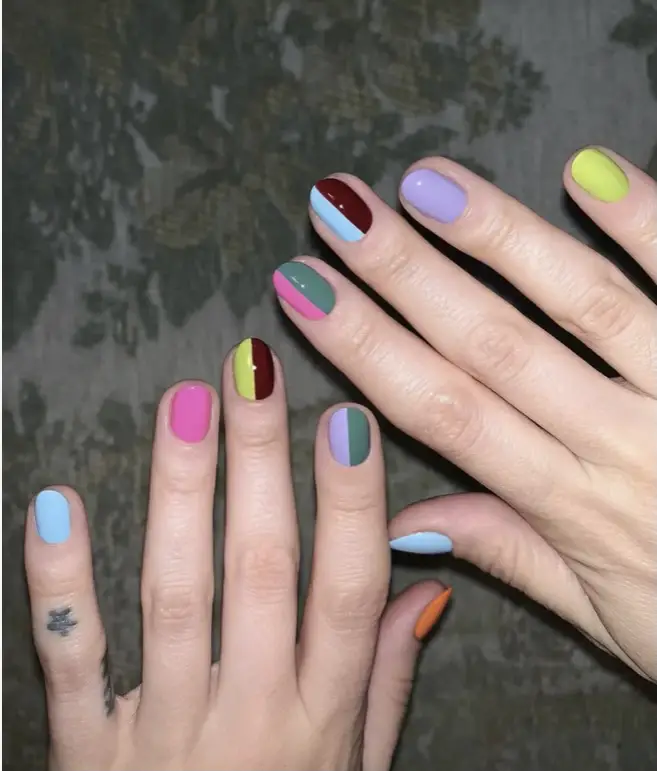 Half and half nail design with vibrant colors and monochrome look