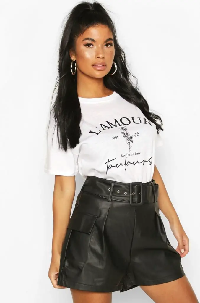 White oversized shirt with faux black leather shorts 