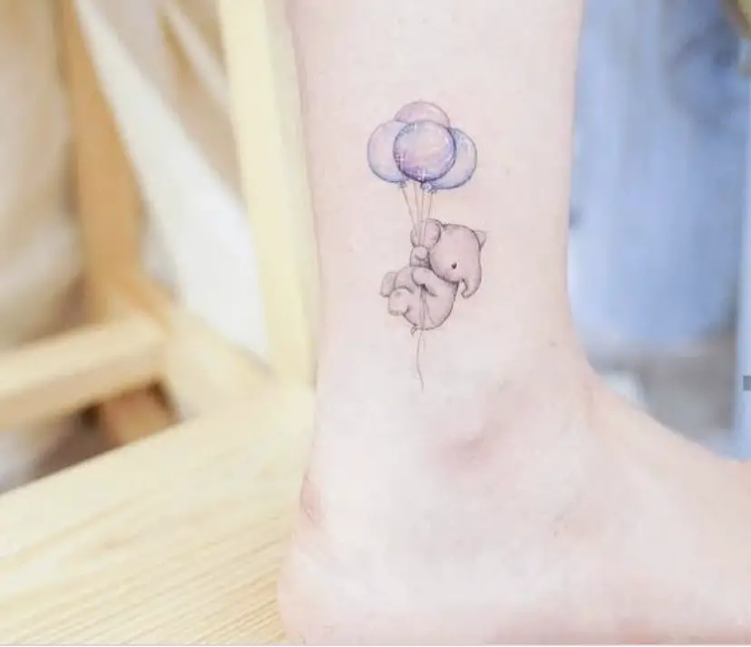 Tiny elephant tattoo with balloons 