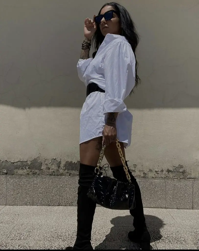 White oversized shirt with belts and knee high boots