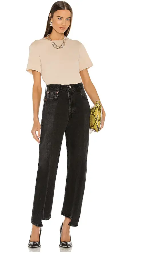 Biere colored oversized t shirt with black denim trousers 