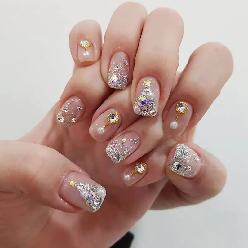 bejewelled pail and rhinestone nails