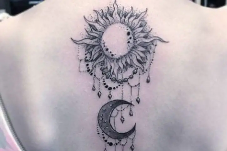 decorated moon tattoo on the back
