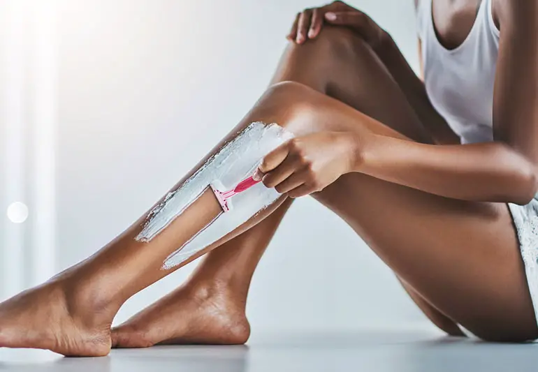 black lady shaving legs