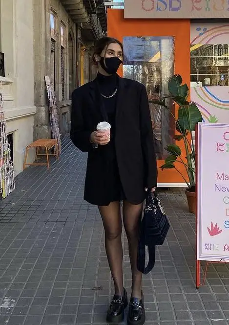 Woman in all black outfit and chunky loafers